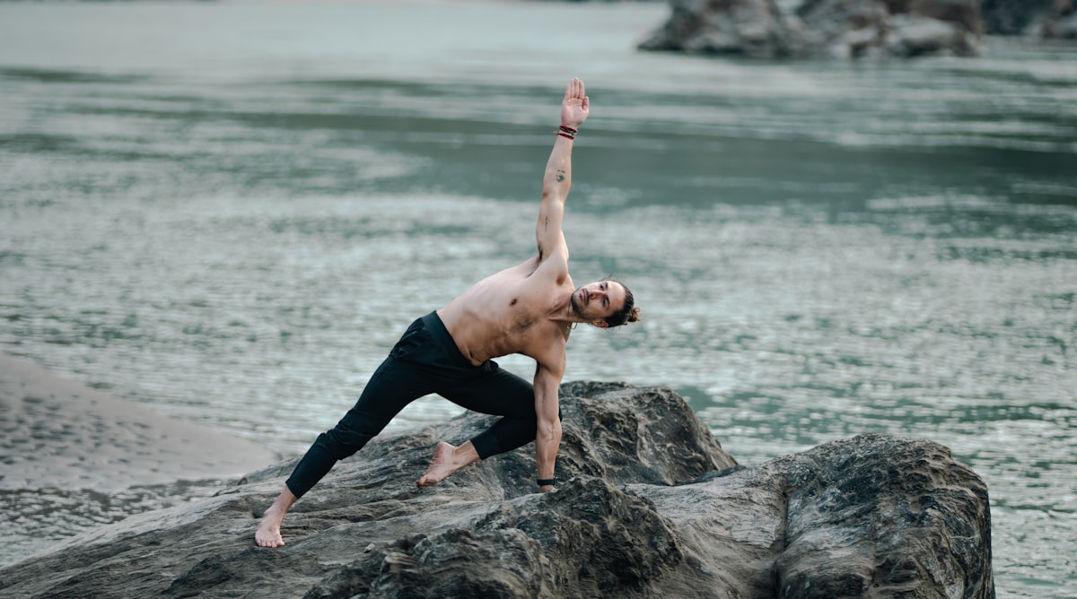 Mature man performing yoga balance pose